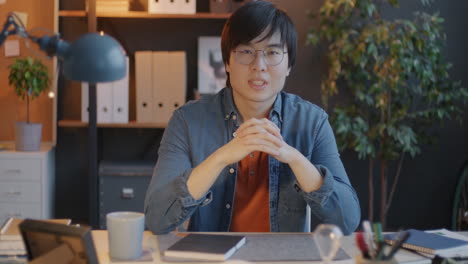 asian man in office setting for video call or presentation