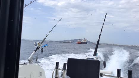 Hand-held-shot-of-fishing-vessels-sailing-through-the-estrecho-de-Gibraltar-from-a-fishing-boat