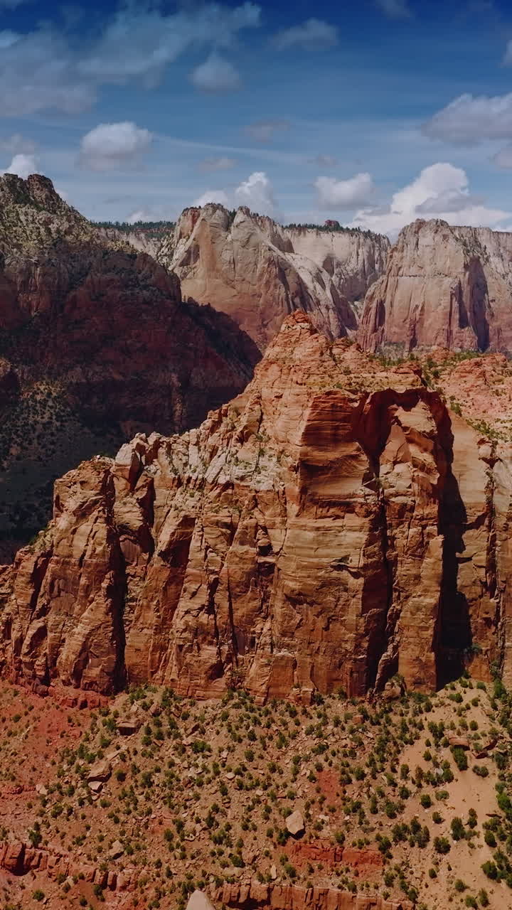 Impressive view of stunning rocks in Zion National Park in Utah, USA. Amazing canyons At the backdrop of bright cloudy sky. Vertical video
