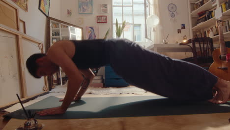 young man having vinyasa yoga practice at home