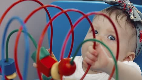 child plays with a multi-colored toy 17