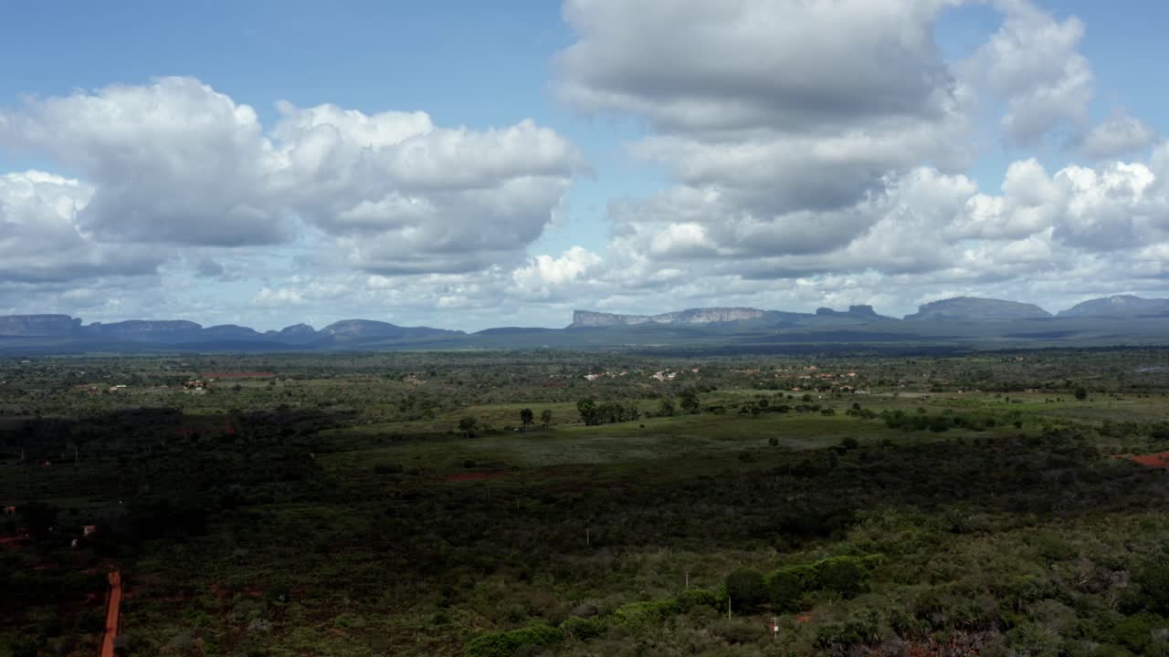 hermosa toma aérea de drones de campos verdes con enormes mesetas en el fondo del parque nacional chapada diamantina en bahia, noreste de brasil en un cálido y soleado día de verano