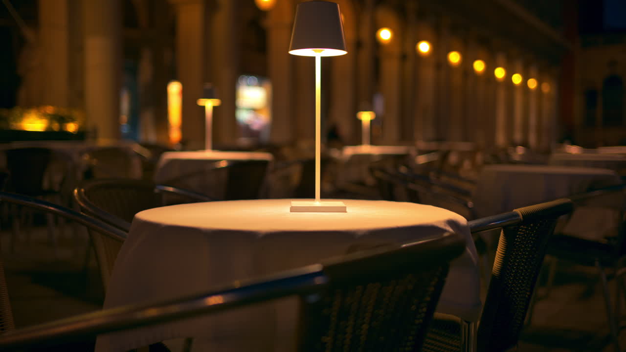 Close up of a lamp on a table in the St. Mark Square in the evening, in Venice, Italy