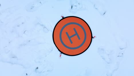 Drone Parking Apron Pad. Lies in the snow. Landing the drone with the camera down. Aerial photography.