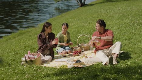 familia disfrutando de un picnic en el parque
