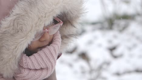 girl in winter clothing in snow