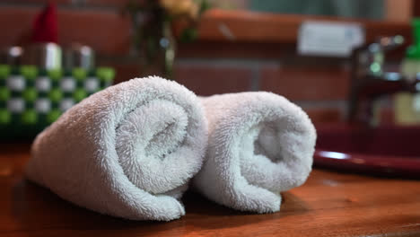 low pan orbit around rolled towels arranged at an eco-lodge in mindo, ecuador, showcasing luxury and sustainability in bathroom