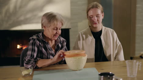 grandmother and granddaughter baking bread together