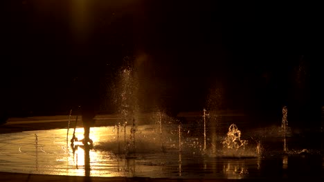 kids playing with water in the city park of denver, colorado