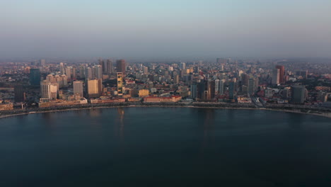 traveling front, sky line luanda city, golden hour flying over luanda bay, africa