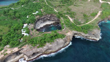 broken beach aerial shot, showing cliffs and ocean waves