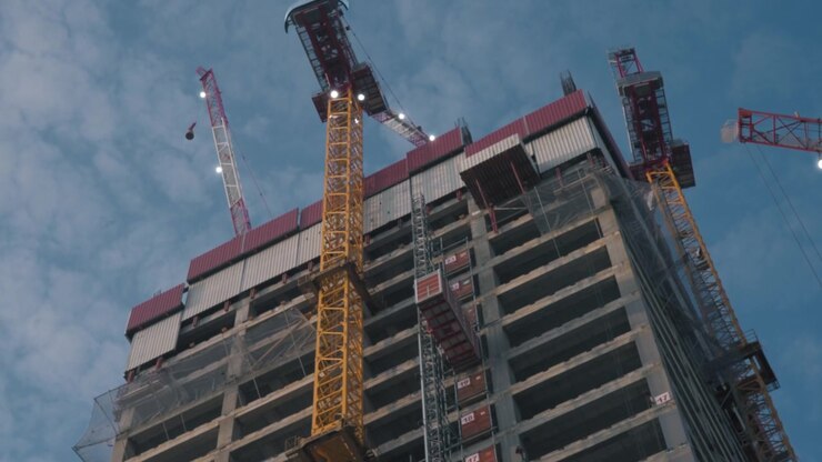 Cranes working on a concrete building