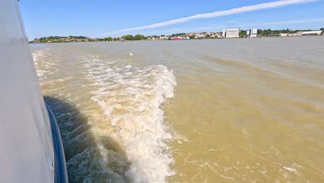 boat creating waves on blaye river, france