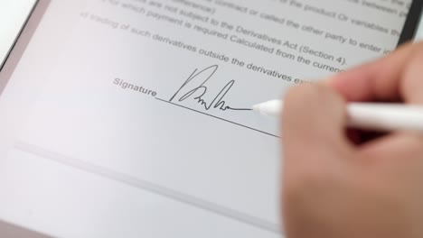 businessman signing a business contract with stylus pen on tablet. man signing contract on tablet at office. business and technology concept. electronic signature concept