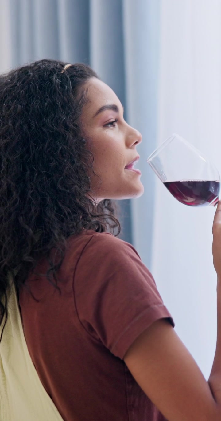 Young Woman Drinking Red Wine at Home