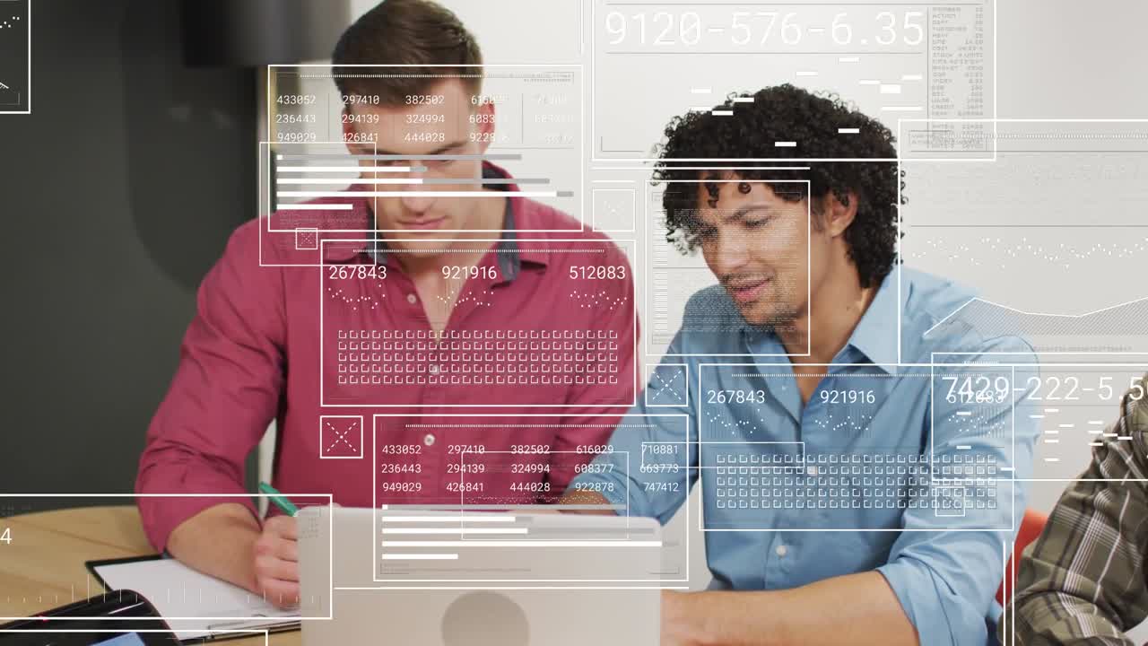 To kolleger arbejder, manden til højre taster, bærbar computer-overlays vises og justeres til analyse