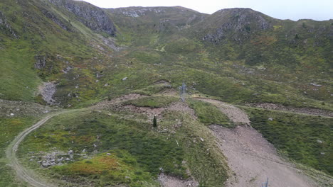 Drone-Shot-over-a-valley-with-a-road-up-to-the-hill