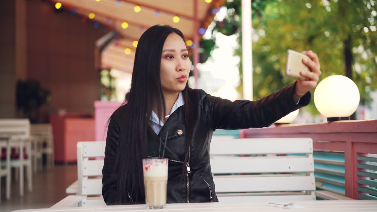 Woman Taking Selfie in a Cafe