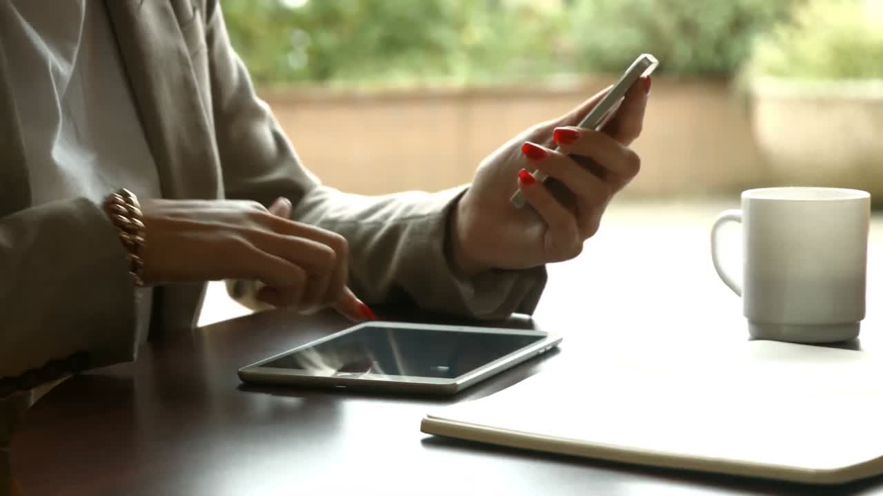 Businesswoman using smartphone and tablet
