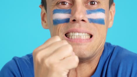 very nervous man supporting salvadoran team during a difficult match
