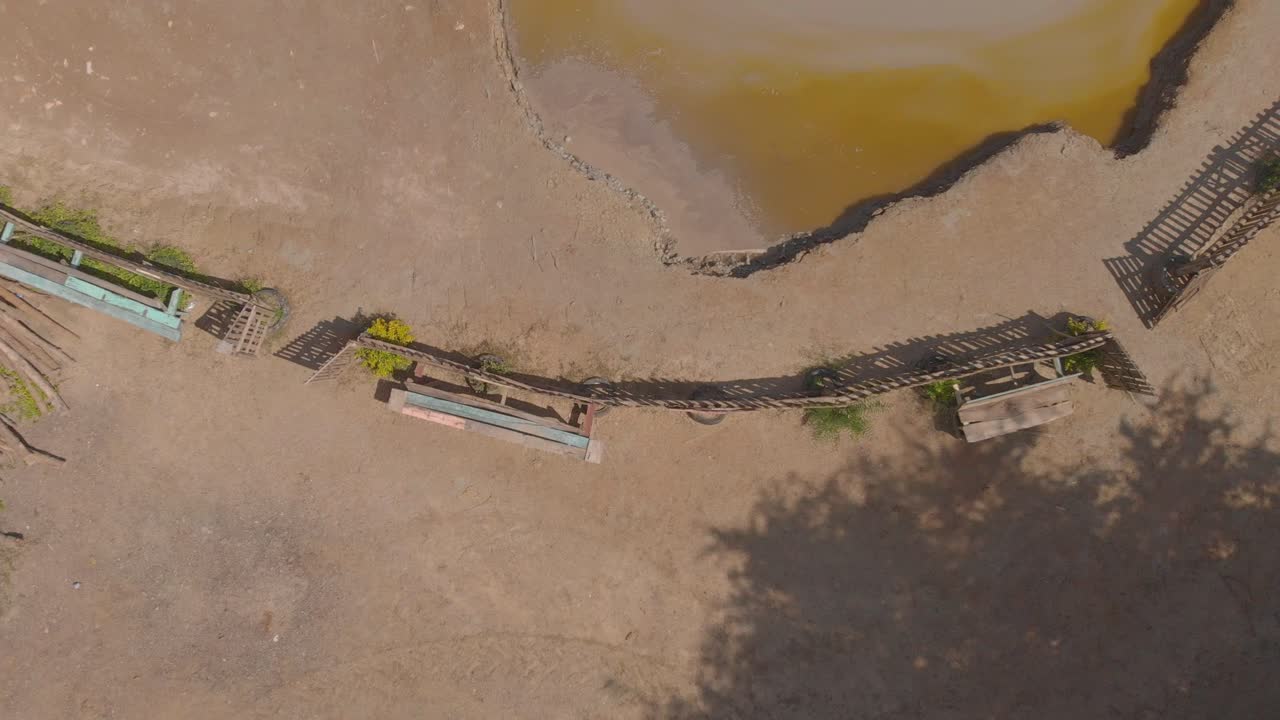 Ascending aerial of a cone shaped mud volcano located in bunsee trace penal, Trinidad and Tobago