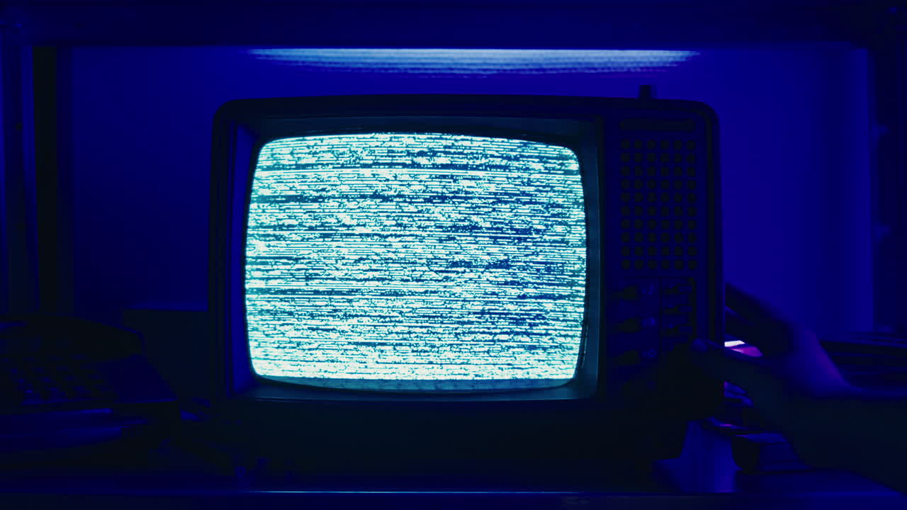 Retro TV, vintage television In a nostalgic setup, a retro TV displays grain on screen, scary halloween night device good for chroma key and green screen.