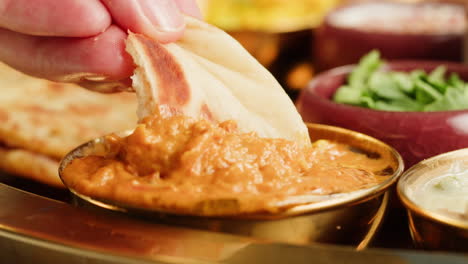 close-up view of a delicious spicy curry served in a colorful bowl with a spoon, ready for a tasty meal.