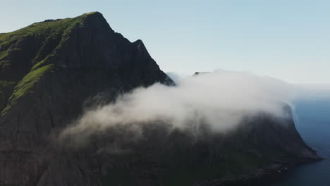 Cinematic-drone-shot-of-clouds-moving-over-cliffs-at-Horseid-Beach