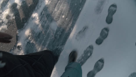 POV-Couple-walking-on-frozen-road-winter