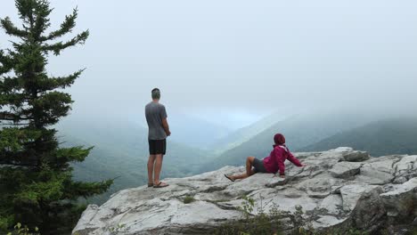 a man and woman at the rohrbaugh cliffs in the dolly sods wilderness, part of the monongahela national forest in west virginia