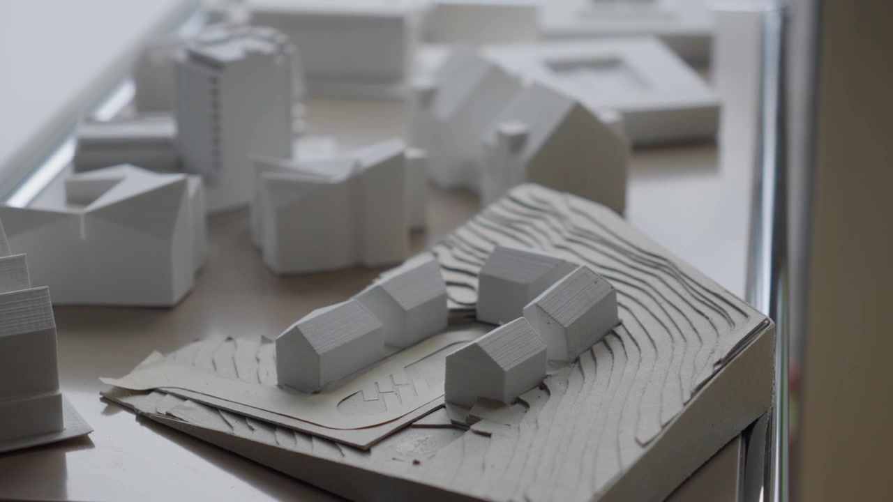 A detailed view of a 3D architectural mockup showing building placement and terrain contours.