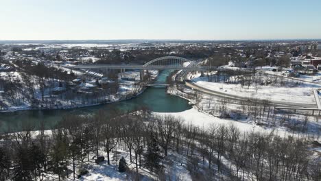 Blue-Sky-Day-flyover-of-suburban-neighborhood-toward-Burgoyne-Bridge,-St