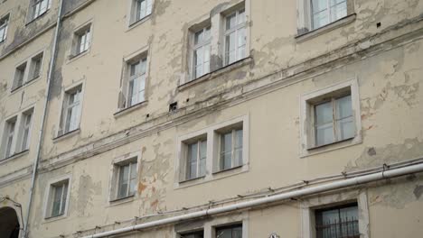 old building with peeling paint and cracked walls