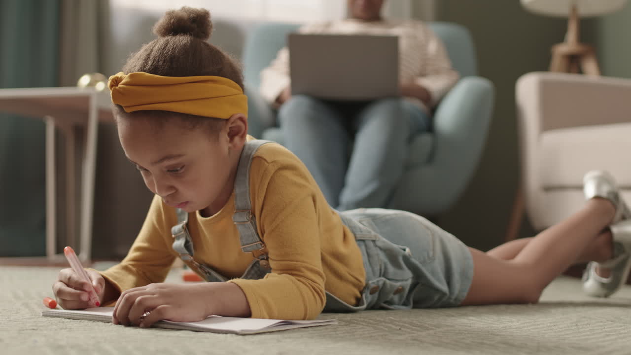 Little African Girl Drawing at Home