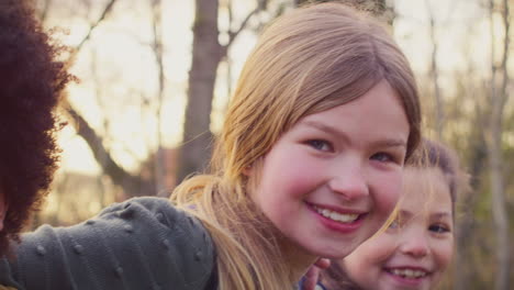 Portrait-Of-Children-With-School-Backpacks-Outdoors-With-Arms-Around-Each-Other