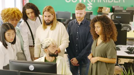 Modern man scolding colleagues seriously in a coworking space