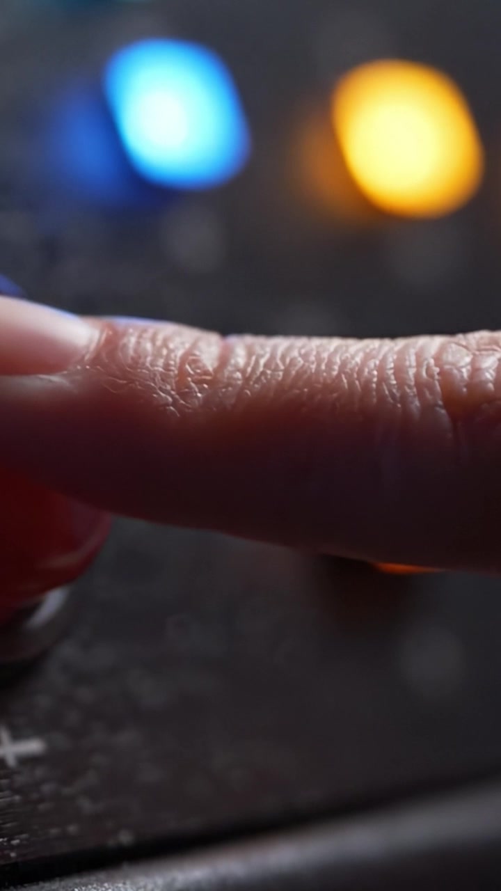 Close-up View of Colorful Control Buttons on a Modern Device Showcasing Vibrant LEDs in Blue, Orange, and Red, Perfect for User Interaction and Feedback.
