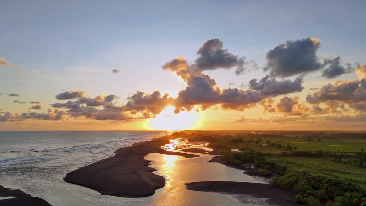 Aerial view of dramatic sunset sky over coastline. Golden cloudy sky over seascape. Amazing beach background.