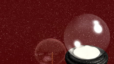 animation of snow falling over christmas snow globe on red background