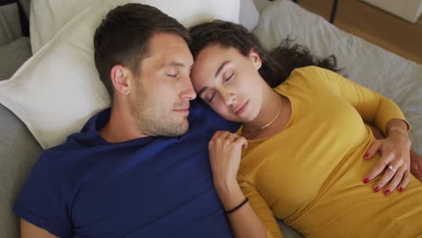 Happy-caucasian-couple-resting-and-taking-a-nap-in-bed