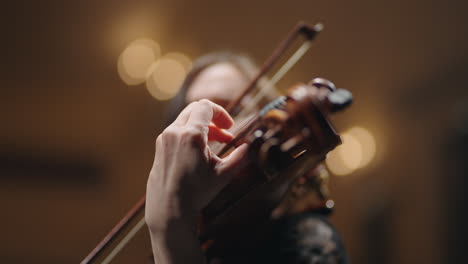 closeup view of old viola in hands of young woman musician is playing music on concert