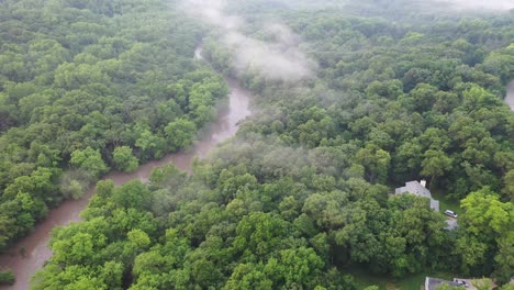 misty river winding through lush green forest