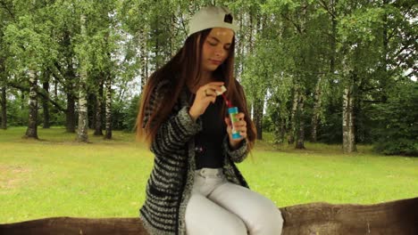 girl blowing bubbles in the nature