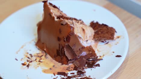 close-up of rich, partially melted chocolate dessert with flakes on a plate. ideal for food, dessert ads, or culinary content