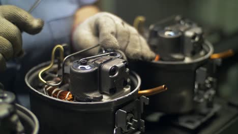 Industrial-worker-hands-checking-electrical-device-after-assembly-at-factory