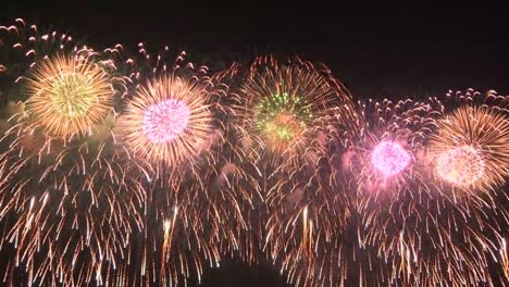 synchronised fireworks celebration in the night sky.