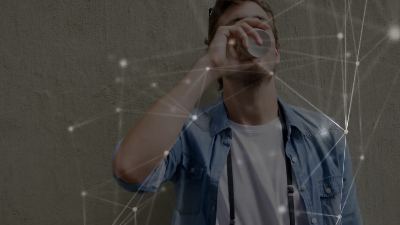 Bearded man drinking from small cup against concrete wall, showing glowing tech network overlay