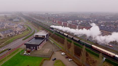 drone follow shot of steam train approaching nijmegen city