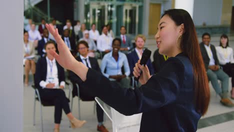 female speaker speaks in a business seminar 4k