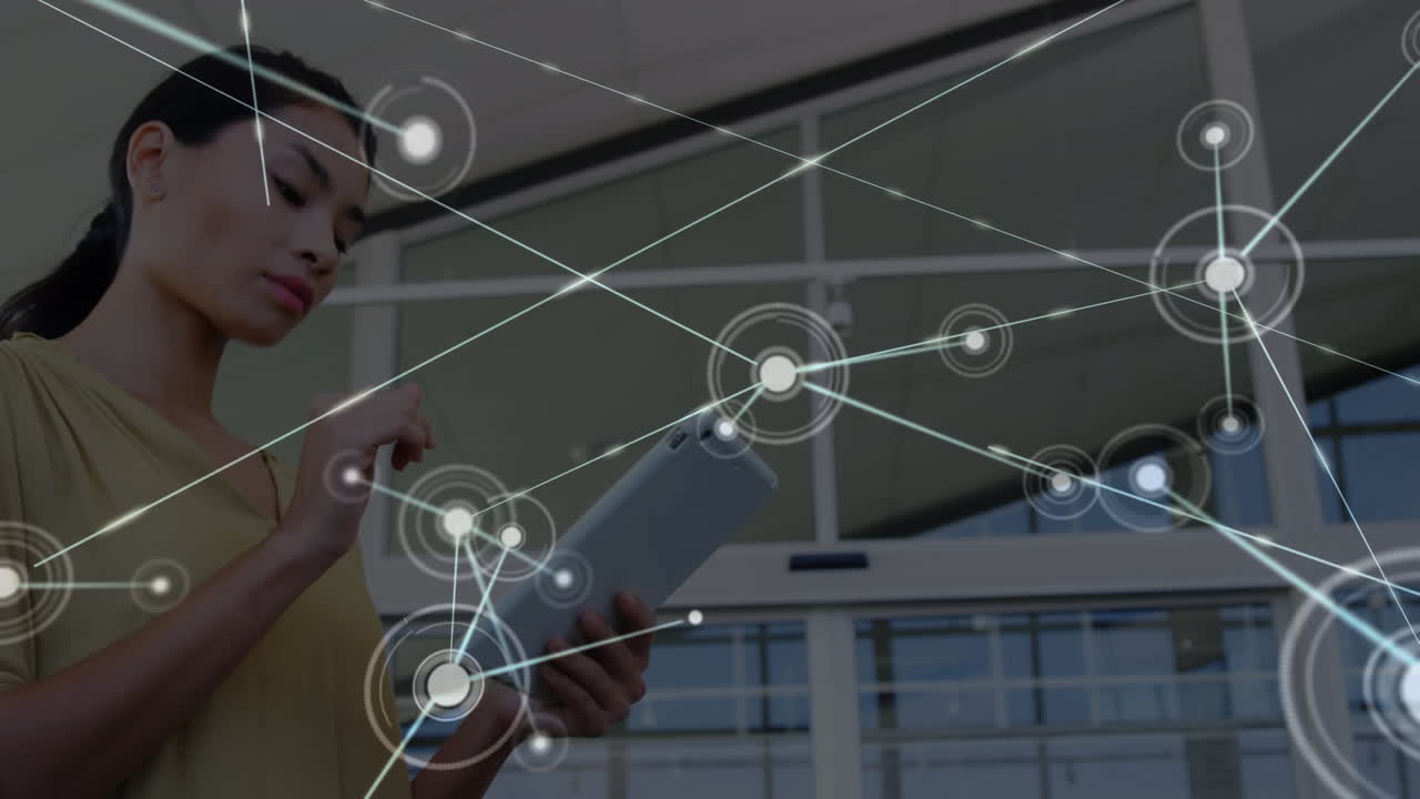 animación de una red de conexiones con iconos sobre una mujer de negocios biracial usando una tableta